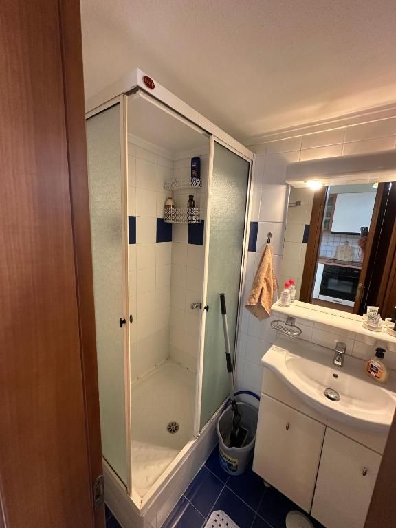 Bathroom at Villa Anastassia with glass shower, sink and mirror